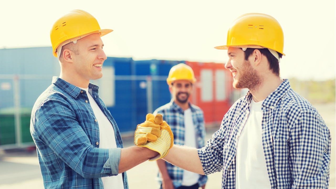 dos hombres se dan la mano en el trabajo