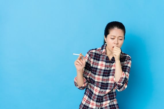 mujer fumando cigarro y tosiendo